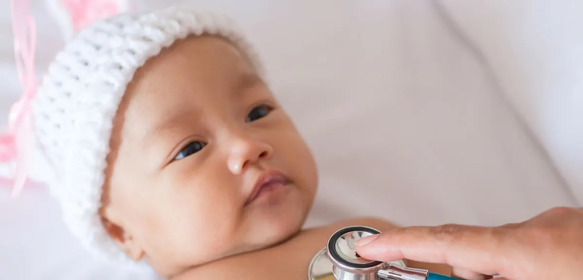 A doctor listens to a baby's heartbeat with a stethoscope